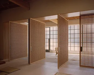 Open-concept space featuring a timber frame design with a minimalist aesthetic.