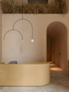 A modern reception desk with a yellow resin finish, featuring minimalist design and sleek lines.