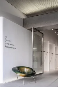 Interior design of a modern retail storefront featuring metal, glass, and concrete materials.