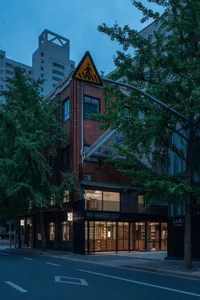 A modern storefront with brick and concrete materials.