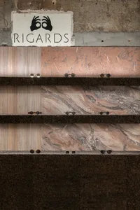 Granite and marble samples displayed in a selection display with sunglasses for scale.
