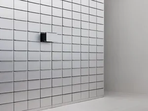 A minimalist storage unit with white metal boxes arranged in a grid pattern.