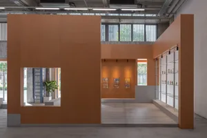 Modern storefront with glass walls and sculptures displayed inside