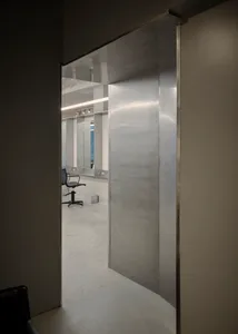 Modern interior design featuring metallic and glass elements.