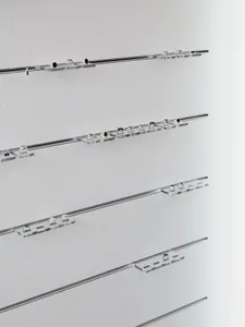 A minimalist display of objects on plastic shelves.