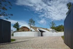 A modern building with a curved, concrete exterior.