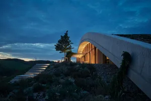 Modern residential exterior with concrete and wood materials at dusk