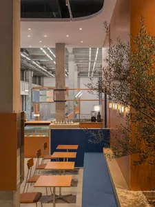 Modern cafe interior with concrete walls, wooden tables, and industrial lighting