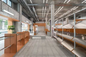 Modern industrial retail interior with metal shelves, concrete walls, and glass displays.
