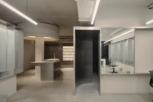 Modern retail storefront featuring contemporary design elements and concrete finishes.