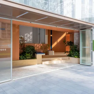 A minimalist retail storefront with concrete and glass elements.
