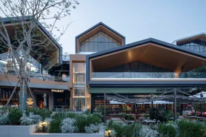 Glass and concrete exterior of a modern shopping center.