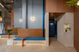 Industrial-themed coffee shop featuring concrete furnishings and minimalist design