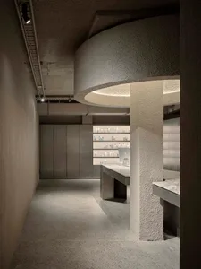 A modern retail storefront with concrete elements and minimalist design.
