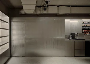 Industrial kitchen with stainless steel appliances and walls