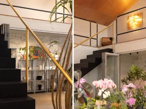 Modern interior space featuring metallic railings, spacious living area, and plants.