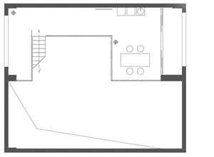 Floor plan of a modern office space showing a staircase, conference table, and meeting area.