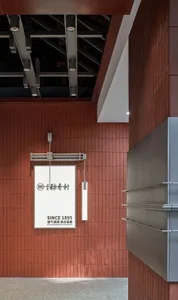 A minimalist retail storefront featuring wood tiles with signage indicating 'SINCE 1895'.