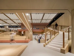 A modern bookstore interior with wooden elements and a contemporary design.