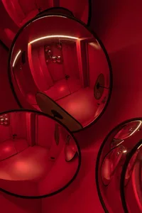 Minimalist interior space with red glass mirrors and metallic elements