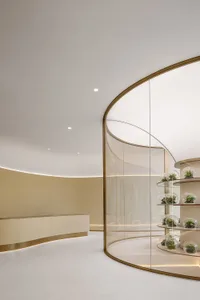 A minimalist retail store interior with glass walls and beige materials