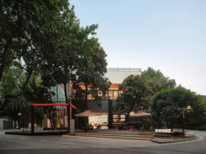 Modern building exterior with wooden accents, glass panels, and concrete structure
