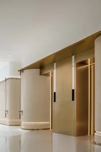A modern interior space featuring metallic columns and minimalist design elements.