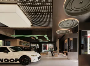 Modern lobby interior with concrete ceiling and minimalist design.