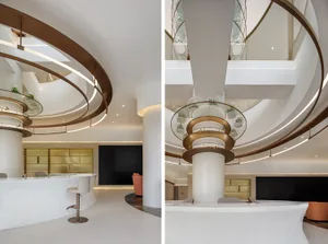 Modern lobby featuring white marble and glass elements.
