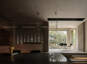 Modern minimalist living space featuring mixed materials and natural light.
