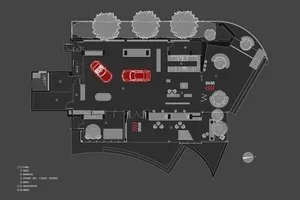 An overhead view of an industrial-style office space featuring exposed metal beams and ductwork.