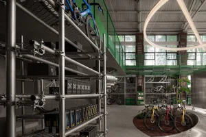 Industrial-style bike shop with metal shelving, concrete flooring, and glass displays.