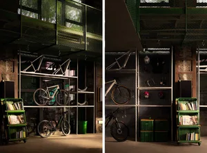 Industrial-style cycling storage and display area with metal shelves, concrete walls, and bicycles.