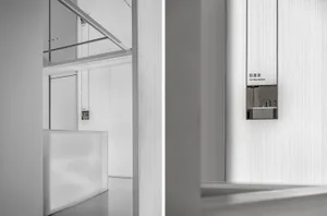 A minimalist office interior with metallic wall panels and sleek, white surfaces.