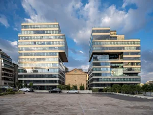 Modern architectural buildings featuring glass exteriors.