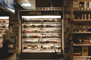 A well-stocked beverage cooler in an industrial-style store.