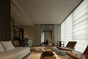 The modern living room features minimalist design with concrete furniture and floor, along with a sleek sofa and coffee table