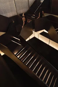 A modern, metallic staircase with a sleek, geometric design.