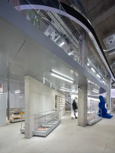 A modern retail store with concrete walls and glass displays.