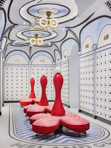 Modern retail shop interior with red and white striped plastic seating and metalacking columns