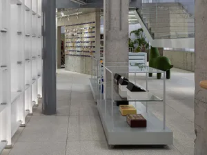 A modern retail shop featuring a transparent display counter with products arranged neatly on shelves.