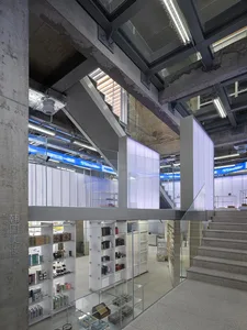 A modern retail storefront with concrete walls, glass displays, and metal accents.
