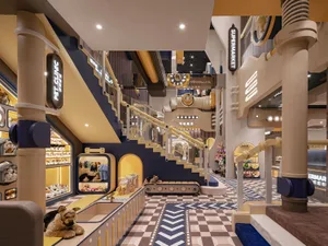 A playful and inviting toy shop interior designed with wooden materials, featuring a staircase, retail areas, and a supermark