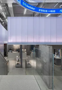 Modern, minimalist coffee shop featuring glass walls and concrete elements.