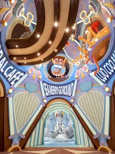 Colorful, whimsical entrance to a retro-themed arcade with metallic and asphalt textures.
