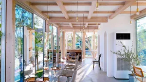 A modern coffee shop featuring glass walls and white walls.