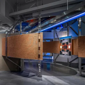 Modern, industrial-style art installation with metal, glass, and wood elements.