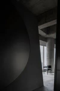 Industrial-style office space featuring concrete ceiling and steel beams