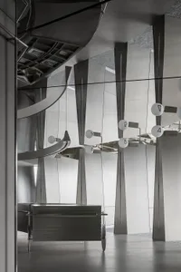 Scalene triangles made of metallic material create a unique and industrial design aesthetic in a corporate space.