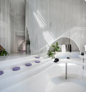 A modern interior space featuring glass walls and white concrete steps.